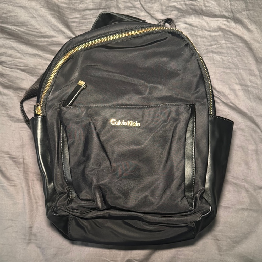 Calvin Klein Black Backpack with Glossy Finish and Multiple Compartments